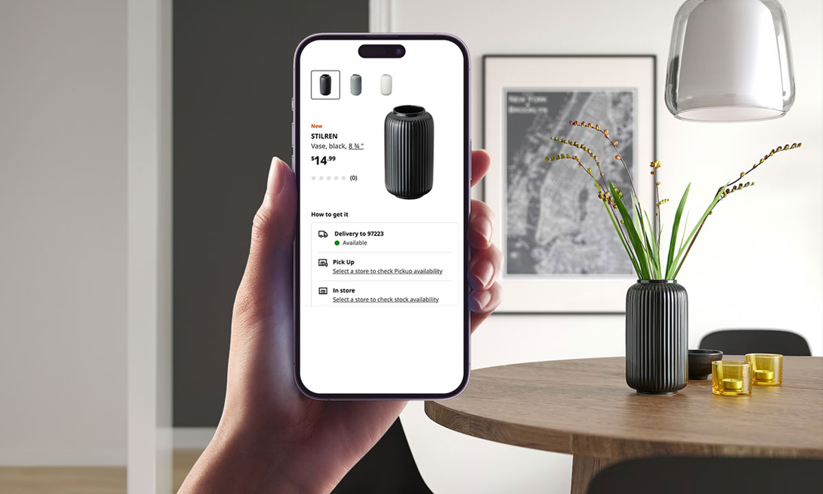 Hand holding a smartphone using visual search to identify a black vase on a table, highlighting the convenience of modern digital shopping