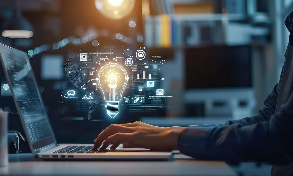 Professional working on a laptop with a holographic overlay of a lightbulb and digital icons symbolizing innovative ideas and digital marketing strategies.