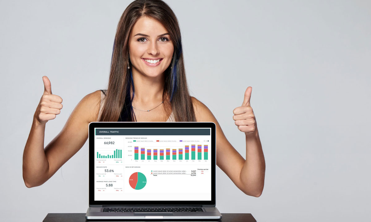 Woman smiling and giving thumbs up while displaying SEO analytics on a laptop screen